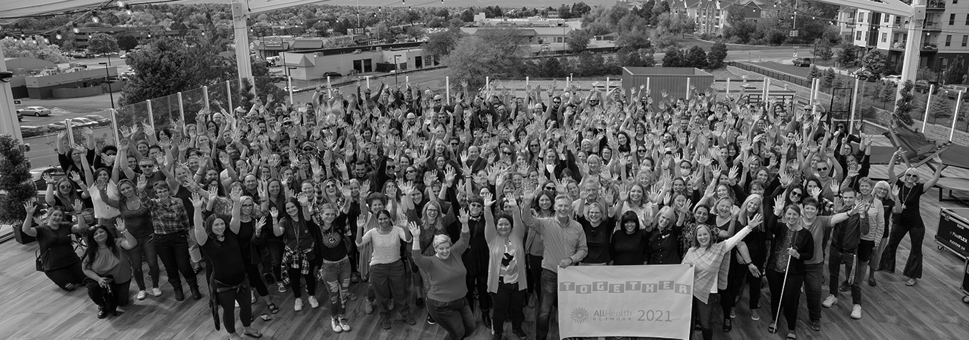 Grayscale group photo of the AllHealth Network staff.